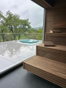 a room with a balcony with a view of a pool at FAIR RESORT All Inclusive Wellness & Spa Hotel Jena in Jena