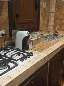 a white toaster sitting on top of a stove in a kitchen at CASA MIKY in Palermo +10 photos