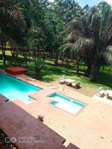 a swimming pool with a picnic table and a bench at Ruby's Guesthouse Chigumula in Blantyre