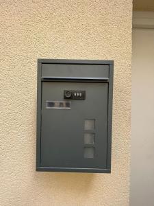 a building with a pay box on the wall at Room & Jacuzzi - Stade de France in Saint-Denis