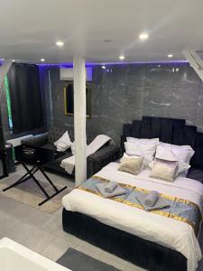 a bedroom with two beds and a piano at Room & Jacuzzi - Stade de France in Saint-Denis