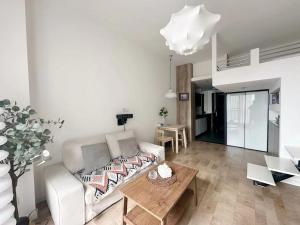 a living room with a white couch and a table at 同济佳苑公寓 in Shanghai