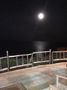 a moon over the ocean at night at Studio appartment beach front in Harqalah