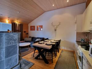 a kitchen and living room with a table and chairs at Kuukkeli Apartments Suite in Saariselka