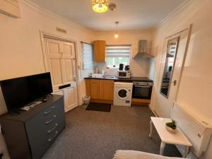 a small kitchen with a sink and a stove at Studio London Hackney near Homerton Hospital in London