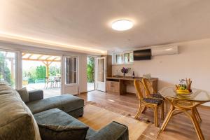 a living room with a couch and a table at House Hortenzia Lake View - Happy Rentals in Révfülöp