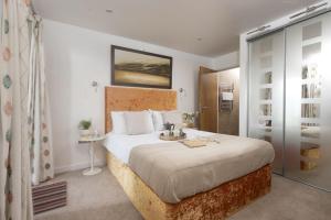 a bedroom with a large bed in a room at Mermaid's Secret, Carbis Bay in Carbis Bay
