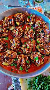 un plato de comida con camarones en salsa roja en Milky Way Bedouin Camp en Wadi Rum