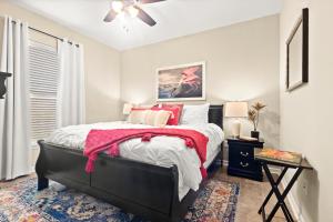 a bedroom with a bed with a red blanket at Plush Bedshigh-speed Wi-fi Workspace in Lake Charles