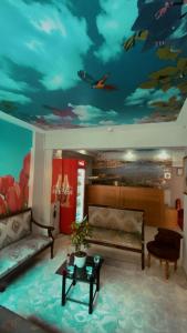 a living room with a painting of fishes on the ceiling at İHVA HOTEL PİERRELOTİ in Istanbul