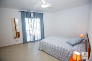 a bedroom with a bed and a ceiling fan at Herminia in La Herradura