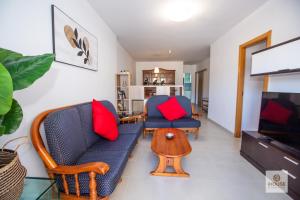 a living room with two chairs and a tv at Herminia in La Herradura
