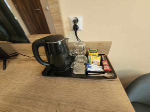 a coffee pot on a tray on a table at Złote Pióro in Nisko