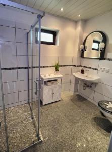 a bathroom with a shower and a sink at Landgang in Wittdün
