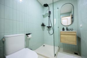 a bathroom with a shower with a toilet and a mirror at 2 Bed 2 Bath / Luxury / 1 min walk to BTS Asok in Bangkok