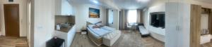 a room with a bed and a television in it at Teddy Apartment in Veliko Tŭrnovo