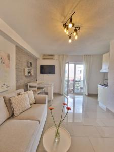 a living room with a couch and a table at Apartments Silva with a view of sea in Trogir
