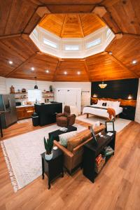 a large living room with a bed and a couch at Romantic Gazebo Cottage w Hot Tub & Pond in Marshallville