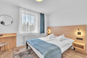 Posteľ alebo postele v izbe v ubytovaní Hotel Za Vodou
