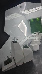 a room with white furniture and potted plants at Optimi Rooms Bilbao in Bilbao