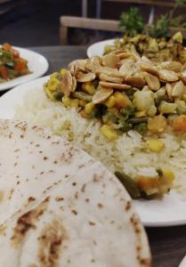 a plate of food with rice and vegetables and a tortilla at the old house in Kerak