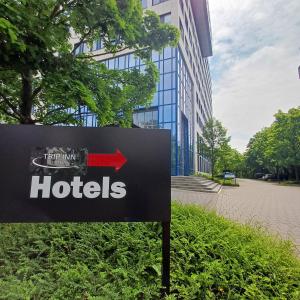 a sign in front of a building with a hotel at Trip Inn Hotel Düsseldorf Neuss in Neuss