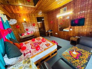 a bedroom with a bed with red decorations on it at Hotel Hamta View Manali !! Top Rated & Most Awarded Property in Manali !! in Manāli