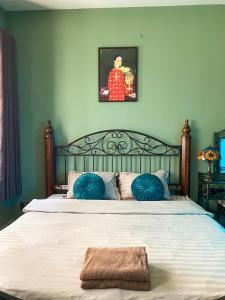 a bedroom with a large bed with blue pillows at A Little Saigon in Ho Chi Minh City