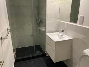 a bathroom with a shower and a sink and a shower at Splendid Apartments - Embassy Gardens in Accra