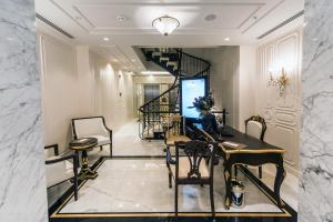 a living room with a staircase and a table and chairs at Arcade Hotel & SPA Nisantasi in Istanbul