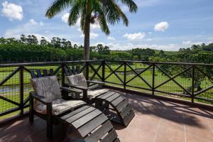 two chairs on a balcony with a view of a field at San Lameer Villa 10412 - 1 Bedroom Classic - 2 pax - San Lameer Rental Agency in Southbroom