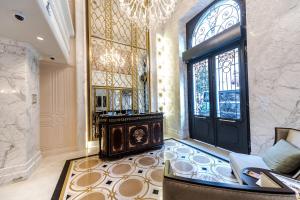 a lobby with a black door and a chandelier at Arcade Hotel & SPA Nisantasi in Istanbul