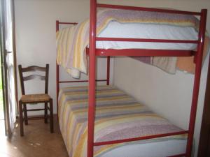 a bedroom with two bunk beds and a chair at Agriturismo Casalino in Beverino