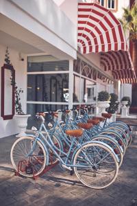 a row of bikes parked in front of a building at Hotel Mongibello Ibiza in Santa Eularia des Riu