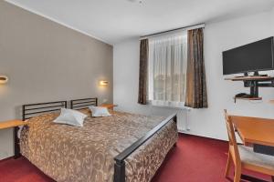 Posteľ alebo postele v izbe v ubytovaní Hotel Za Vodou