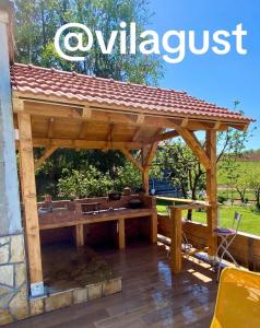 a wooden pavilion with a roof on a patio at Vila GUŠT in Zlatibor