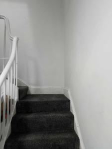 a staircase in a room with white walls at Penrith in Penrith