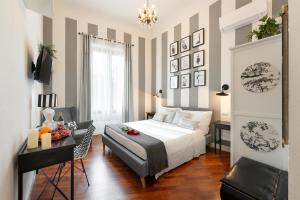 a bedroom with a bed and a table and a desk at Entire flat with 6 Rooms & 6 Bathrooms, 210 SQMs at Most Historical Center with LIFT !!! in Florence