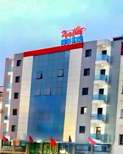 a building with a sign on top of it at Majliss Hotel Downtown in Rabat