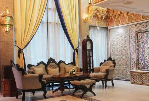 a living room with a table and chairs and a window at Majliss Hotel Downtown in Rabat