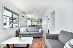 a living room with two couches and a table at Tasman Holiday Parks - Fraser Coast in Hervey Bay