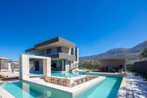 een villa met een zwembad met bergen op de achtergrond bij Elinor Villa in Chania +40 foto's