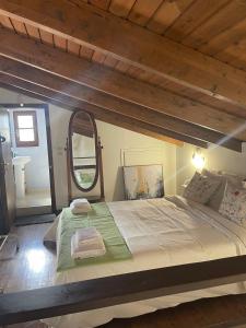 a bedroom with a large bed with a large mirror at Villa Thea sitia in Sitia
