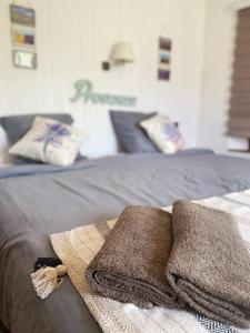 a bed with two towels sitting on top of it at LPSV Experience B&B in La Palud sur Verdon in La Palud-sur-Verdon