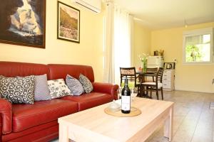 a living room with a red couch and a table at Jelena in Cetinje