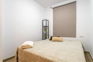 - une chambre dotée d'un lit avec un grand écran sur le mur dans l'établissement Bettatur Apartament Anfiteatre Romà, à Tarragone