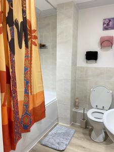 a bathroom with a toilet and a sink at Stanton - Impeccable and stylish 2 bedroom in Dagenham