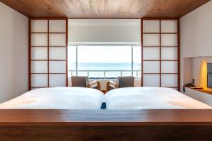 Ένα ή περισσότερα κρεβάτια σε δωμάτιο στο Kameya Hotel