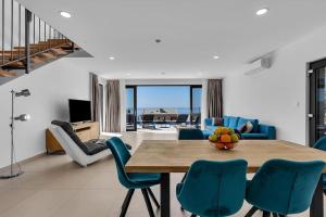 a dining room with a table and blue chairs at Ferienhaus Komplex - Villa David - Makarska Exklusiv in Veliko Brdo +14 photos