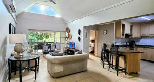 a living room and kitchen with a couch and a table at 6 The Bridge Self Catering Apartment in St Lucia